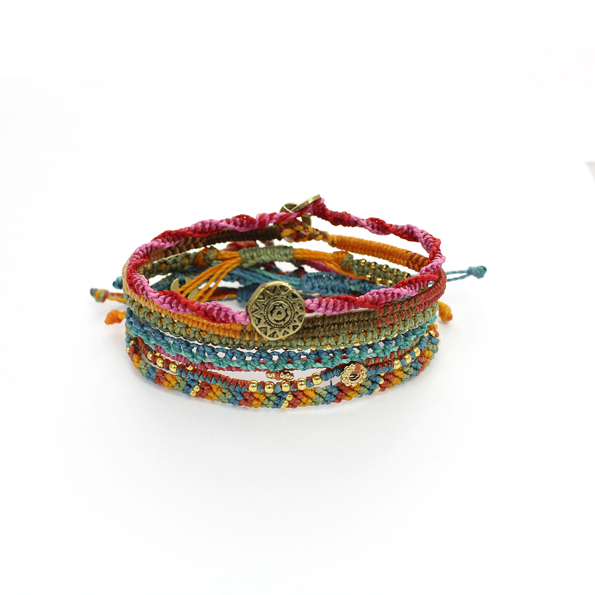 Colorful handmade woven bracelets with various beads and a central decorative bronze charm.